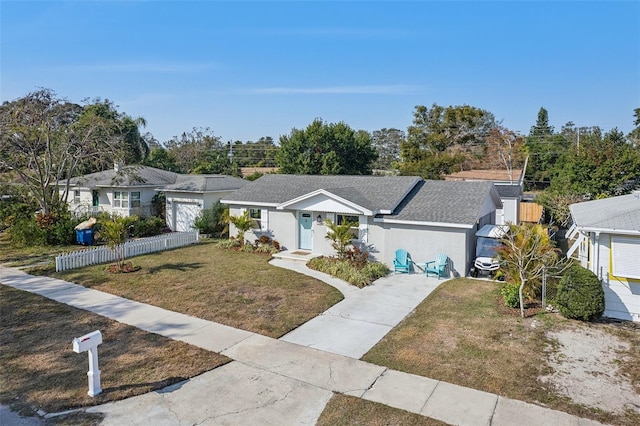 single story home with a residential view, roof with shingles, fence, a front lawn, and stucco siding