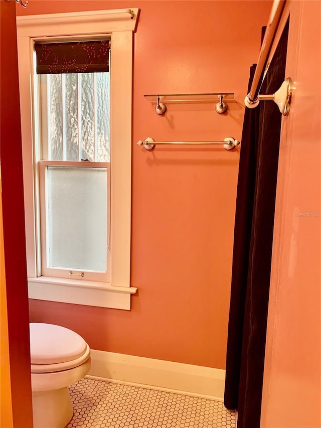 bathroom featuring tile patterned floors and toilet