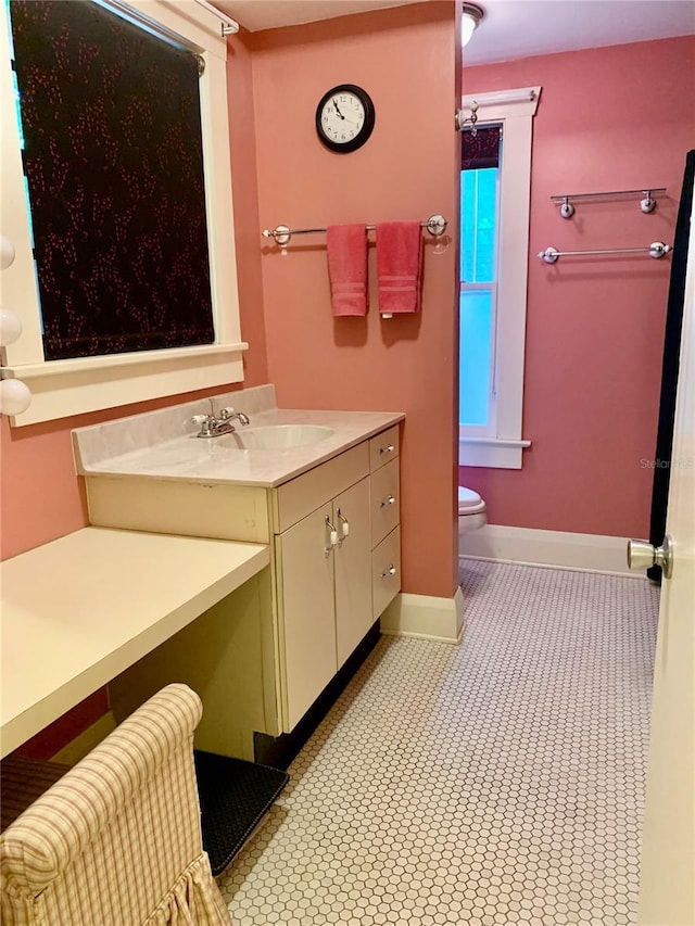 bathroom featuring tile patterned floors, vanity, and toilet