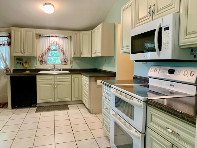 kitchen with sink, white appliances, cream cabinetry, and light tile patterned flooring