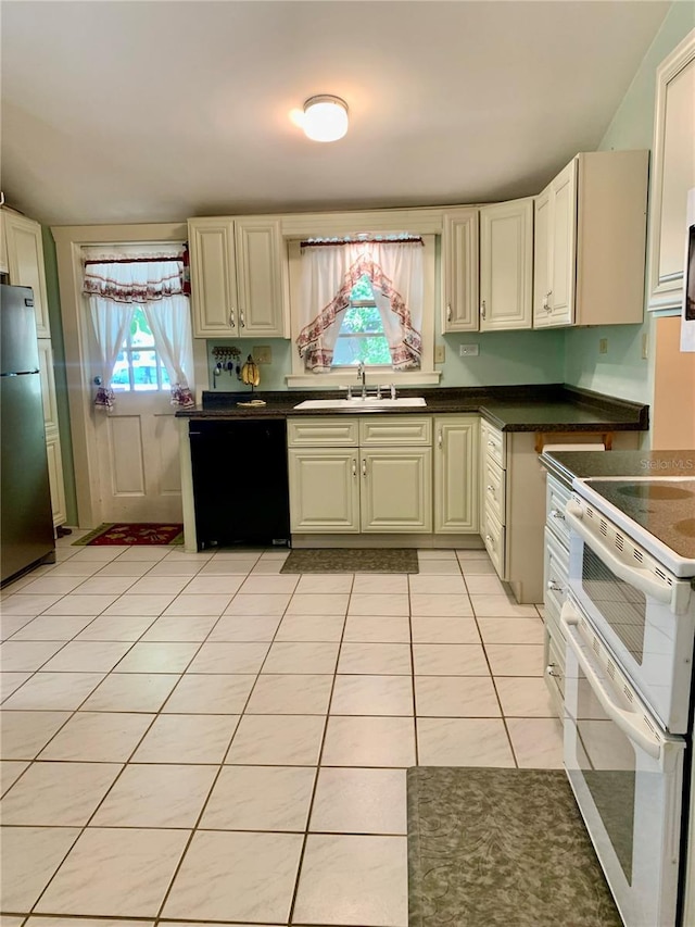 kitchen with light tile patterned floors, sink, stainless steel refrigerator, dishwasher, and double oven range