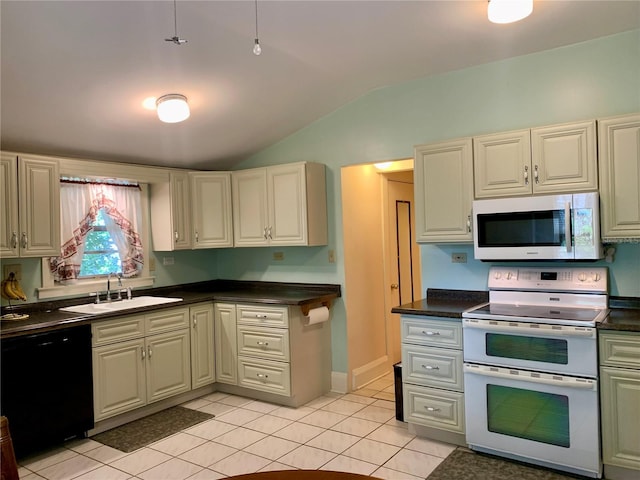 kitchen featuring lofted ceiling, sink, white appliances, and light tile patterned flooring