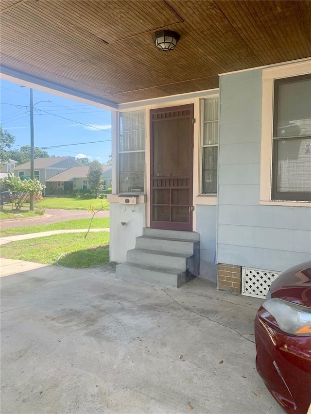 entrance to property featuring a yard