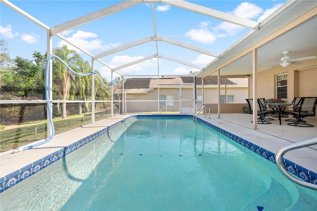 view of pool featuring a lanai, a patio area, and ceiling fan