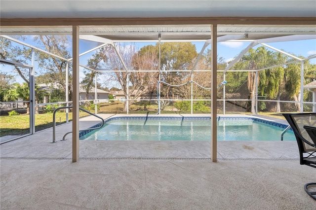 view of pool with a patio and a lanai