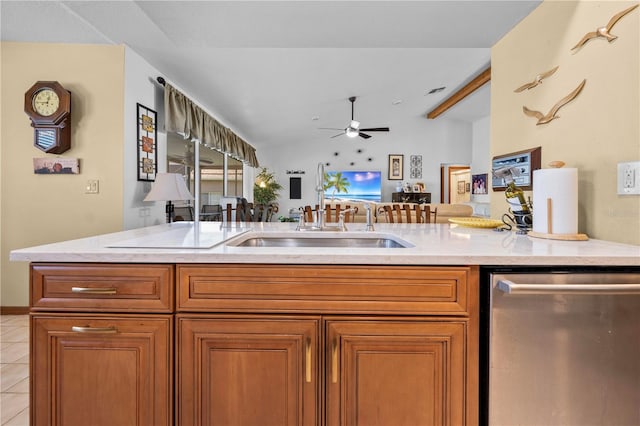 kitchen with sink, vaulted ceiling with beams, light tile patterned floors, stainless steel dishwasher, and ceiling fan