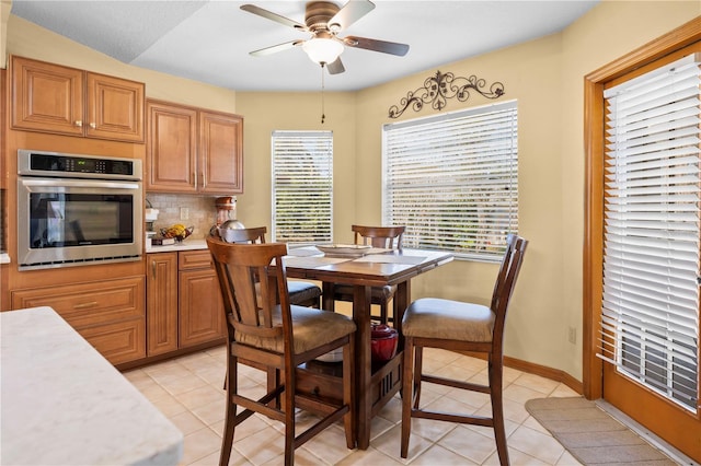 dining area featuring light tile patterned floors and ceiling fan