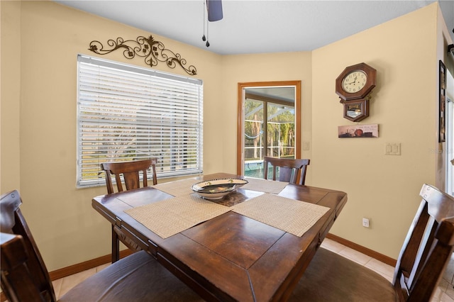 dining space with ceiling fan and light tile patterned floors