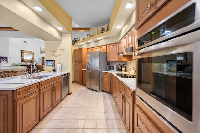 kitchen featuring light tile patterned flooring, appliances with stainless steel finishes, sink, and backsplash