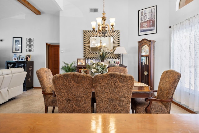 tiled dining room featuring beamed ceiling, a high ceiling, a healthy amount of sunlight, and an inviting chandelier