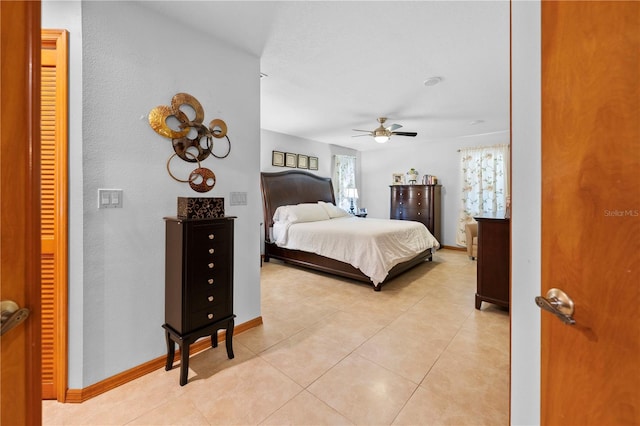 tiled bedroom featuring ceiling fan