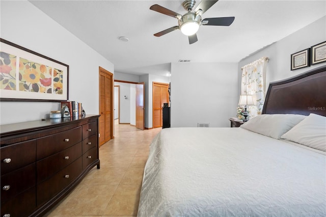 bedroom with ceiling fan and light tile patterned flooring