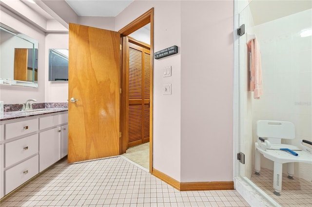 bathroom with a tile shower and sink