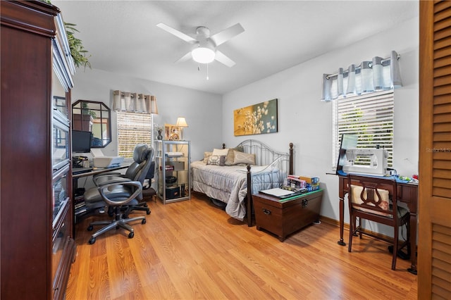 bedroom with ceiling fan and light hardwood / wood-style flooring