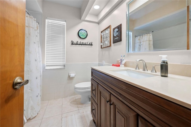 bathroom with tile patterned flooring, vanity, tile walls, and toilet