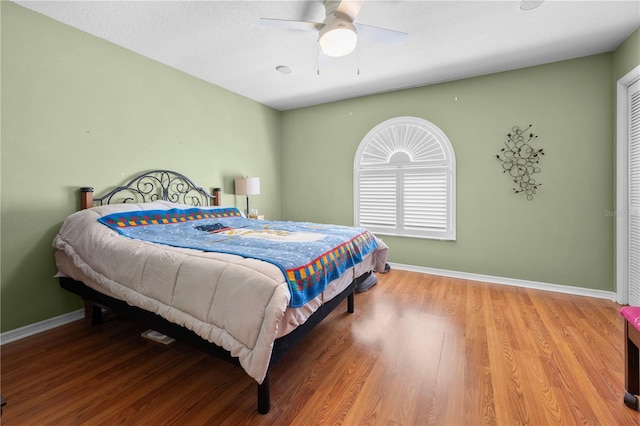 bedroom featuring hardwood / wood-style flooring and ceiling fan