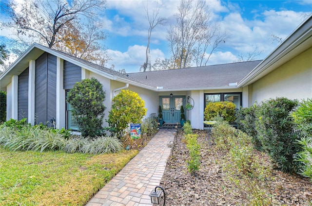 view of exterior entry featuring french doors