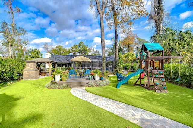 exterior space with a playground and an outdoor stone fireplace