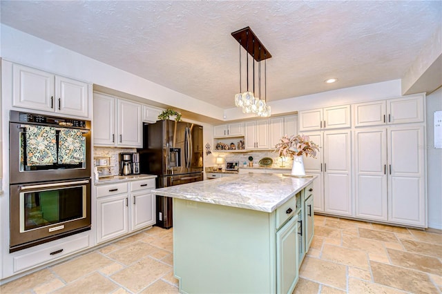 kitchen featuring pendant lighting, a center island, light stone counters, double wall oven, and white cabinets