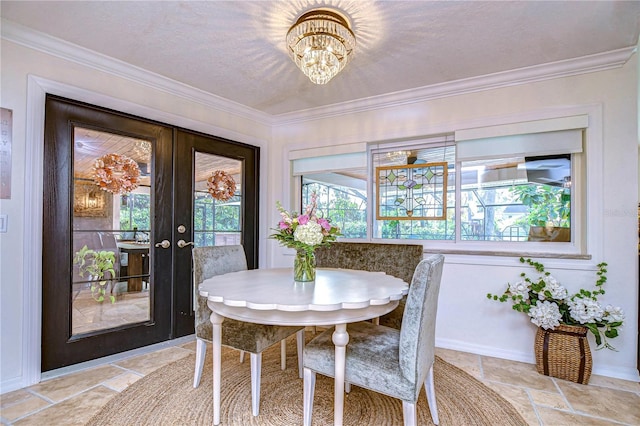 dining room featuring crown molding, an inviting chandelier, and french doors