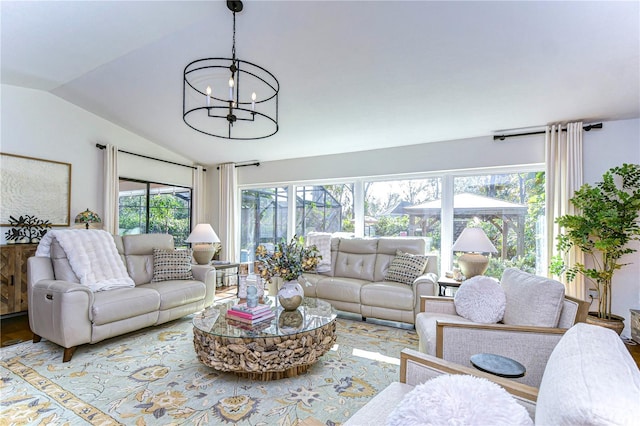 living room featuring lofted ceiling and an inviting chandelier