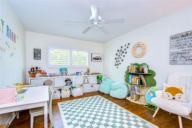 playroom with dark hardwood / wood-style floors and ceiling fan