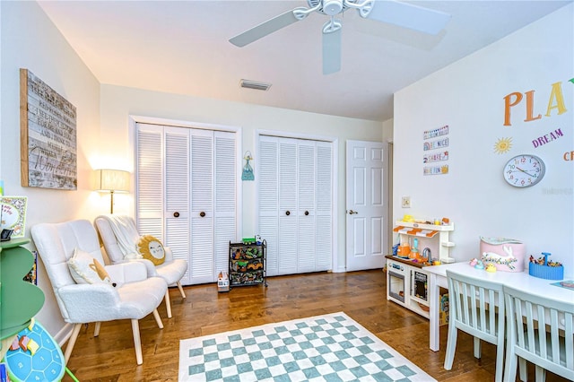 interior space featuring dark wood-type flooring and ceiling fan