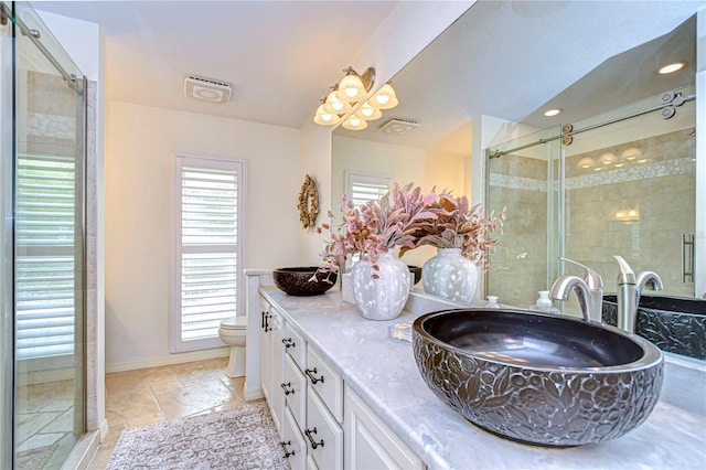 bathroom with walk in shower, vanity, and toilet