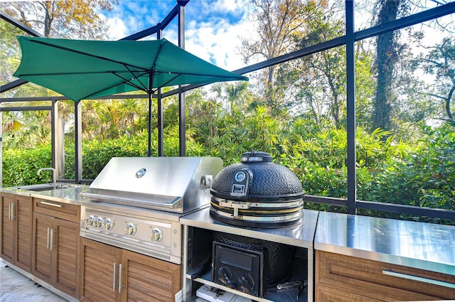 view of patio with area for grilling, a grill, and sink