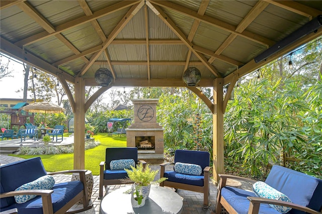 view of patio / terrace featuring a gazebo and an outdoor living space with a fireplace