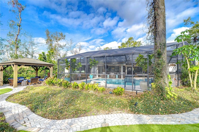 view of pool with a gazebo, a lanai, an outdoor hangout area, and a lawn