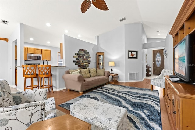 living room with ceiling fan and light wood-type flooring