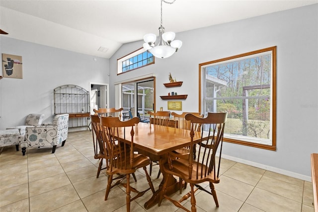 dining room with lofted ceiling, light tile patterned floors, and a notable chandelier