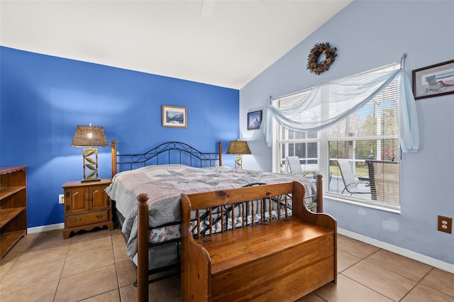 tiled bedroom featuring vaulted ceiling