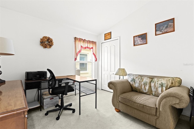 carpeted home office featuring vaulted ceiling