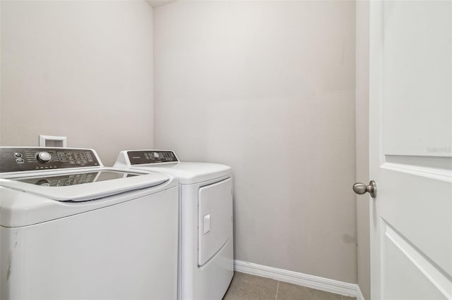 laundry room featuring light tile patterned flooring and washer and dryer