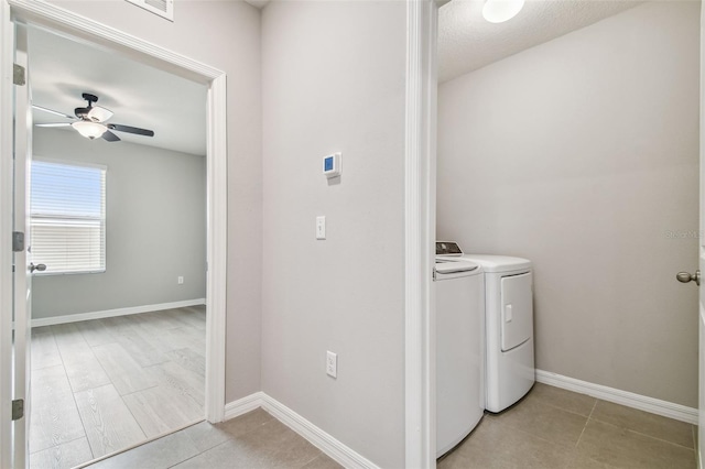 laundry room with light tile patterned flooring, ceiling fan, and washer and clothes dryer