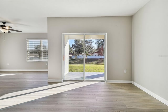 doorway to outside featuring ceiling fan and light wood-type flooring