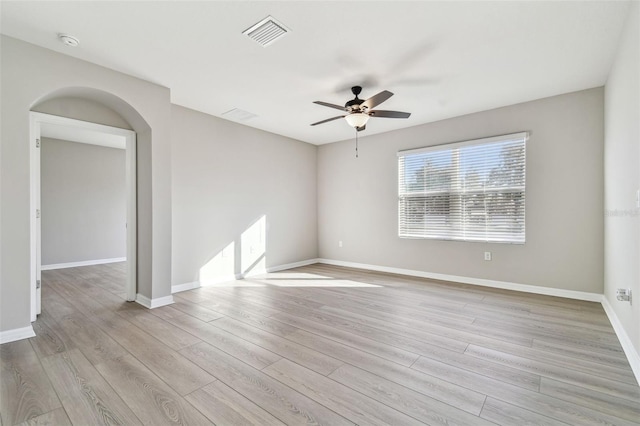 spare room with ceiling fan and light wood-type flooring