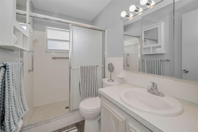 full bath featuring a shower stall, toilet, and vanity