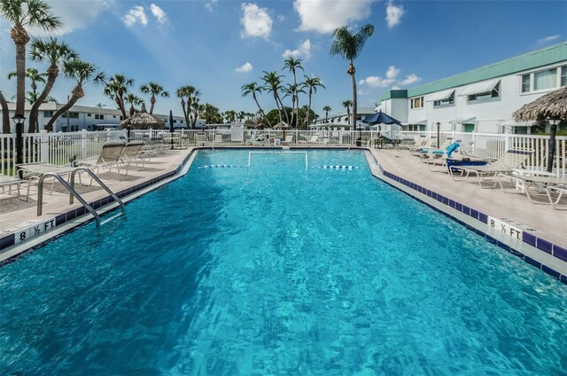 pool with a patio and fence