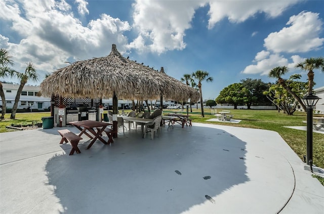 view of community with a gazebo, a lawn, and a patio area