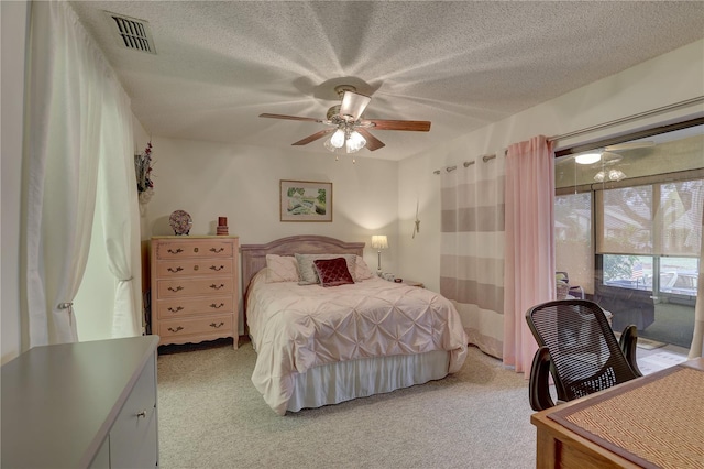 carpeted bedroom featuring ceiling fan, a textured ceiling, and access to outside