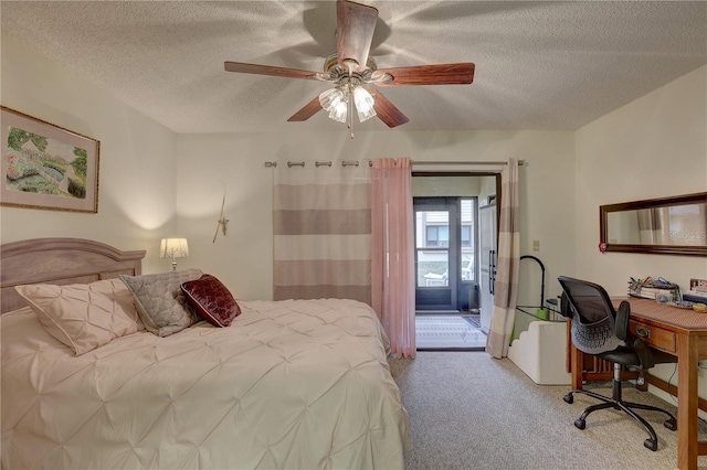 bedroom featuring light colored carpet, a textured ceiling, and ceiling fan