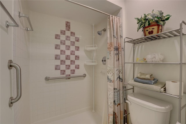 bathroom featuring walk in shower and toilet