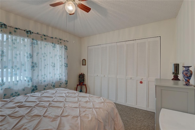 bedroom featuring a textured ceiling, a closet, ceiling fan, and carpet flooring