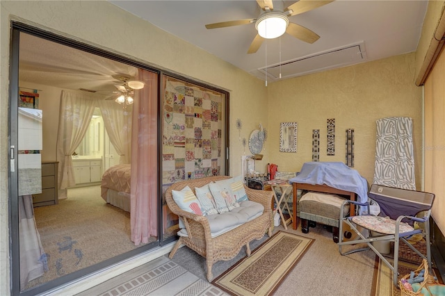 living area with ceiling fan and carpet floors