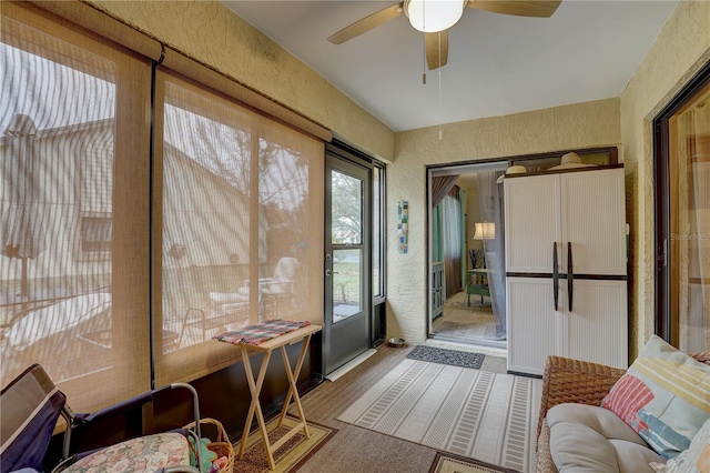 sunroom / solarium featuring ceiling fan