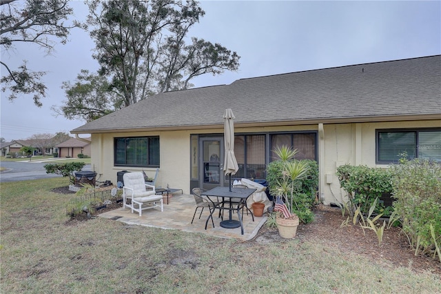 back of property featuring a yard and a patio area