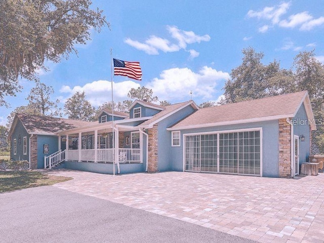 view of front of house featuring a garage and covered porch